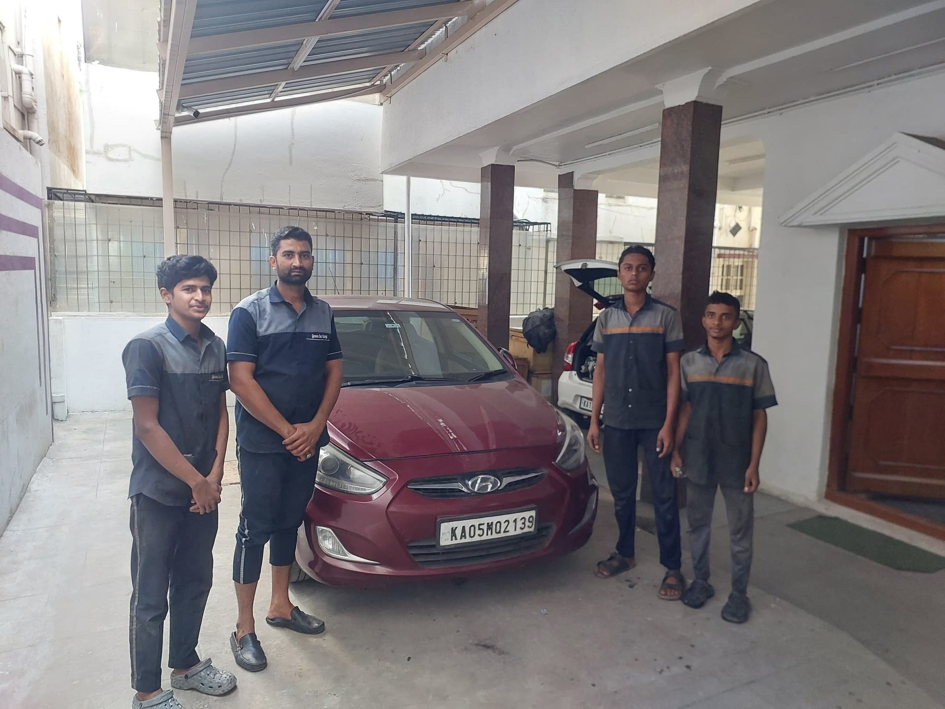 Qaswa Car Garage team with a maroon Hyundai in the workshop